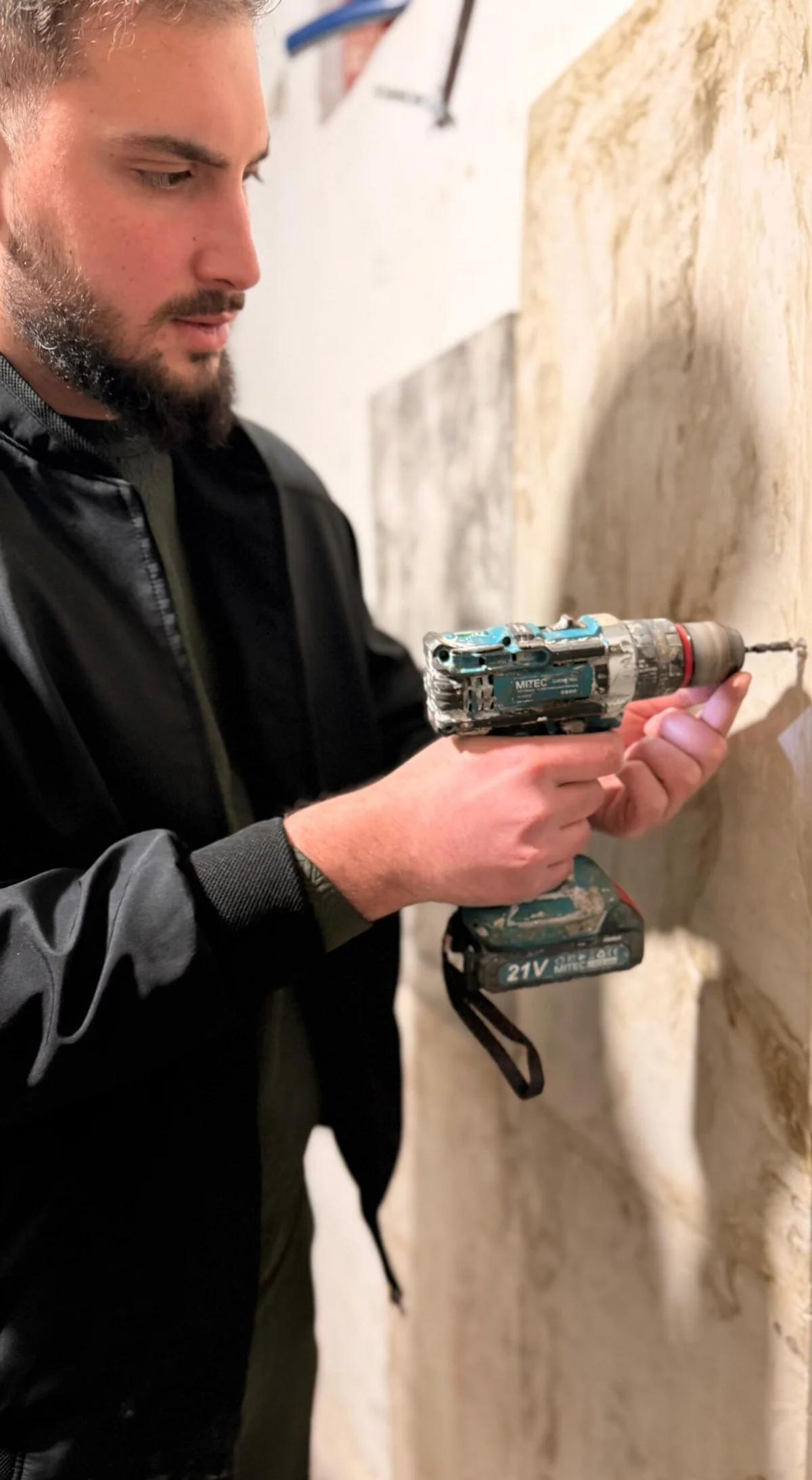 A Rumett panel being fixed in place with a cordless driver