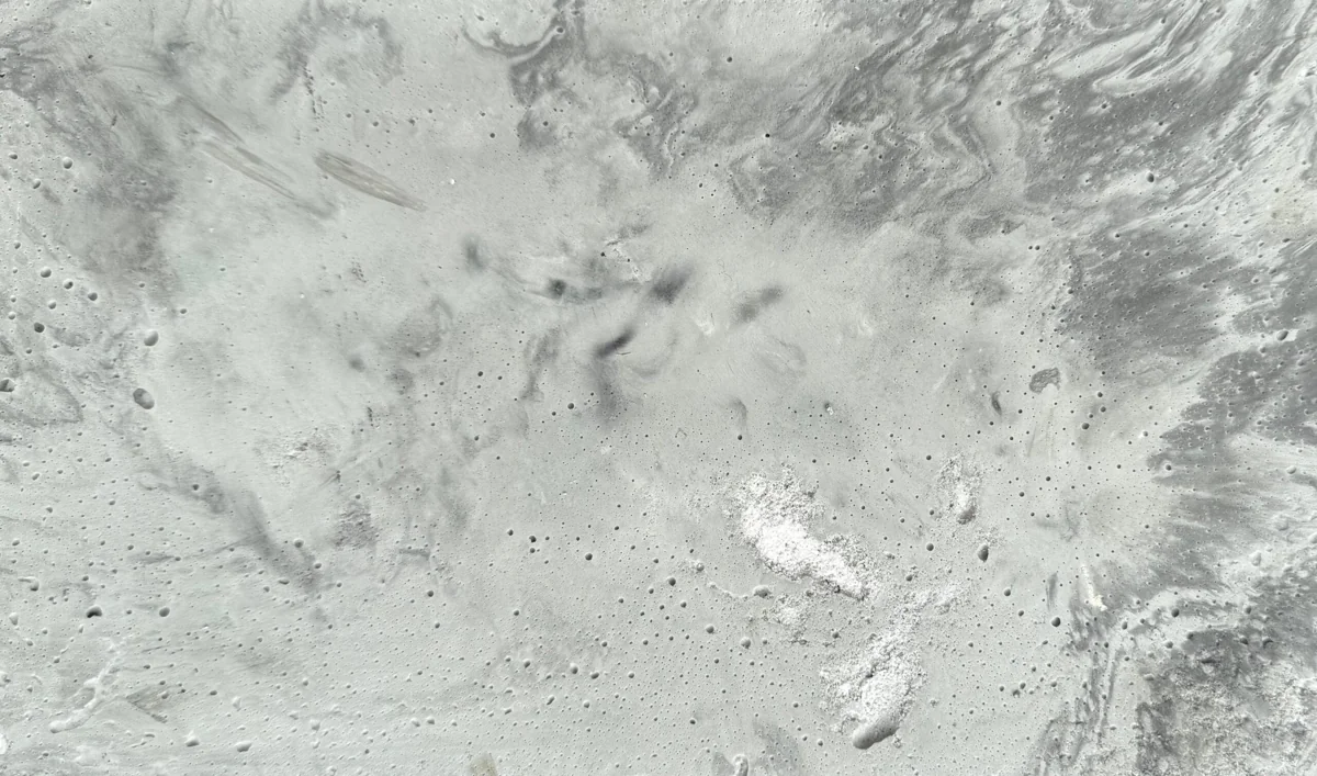 Flowing grey veins and pores in a real Rumett mineral surface